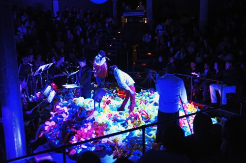 The Roots performing live among some balloon animals.  Photo by Mel D. Cole taken with respect from Okayplayer.